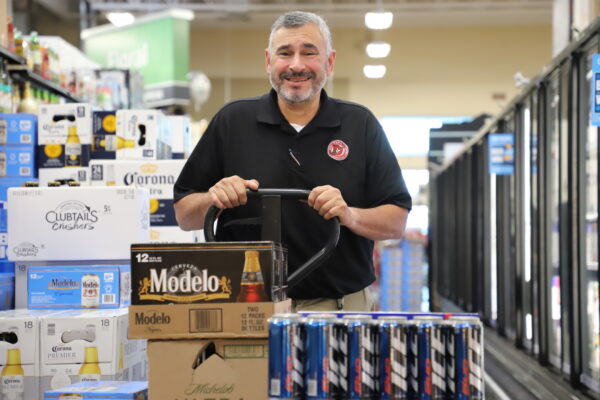 A Del Papa employee pushes a cart of beverages.