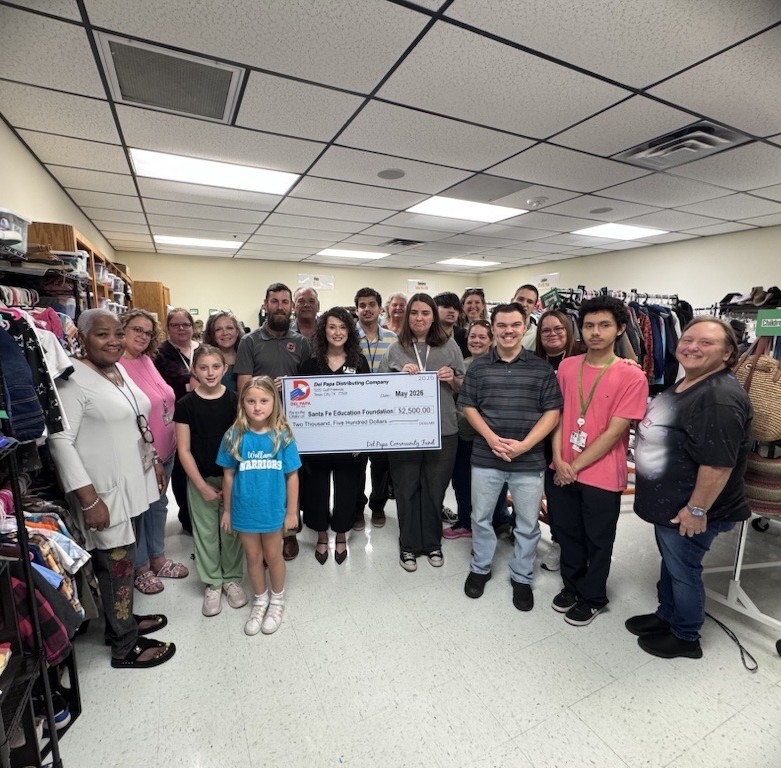 Emily presents a check to an organization.
